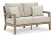 Hallow Creek Outdoor Loveseat with Cushion - Home Furniture And More (Brentwood, MD)