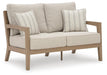 Hallow Creek Outdoor Loveseat with Cushion - Home Furniture And More (Brentwood, MD)