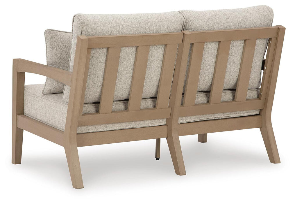 Hallow Creek Outdoor Loveseat with Cushion - Home Furniture And More (Brentwood, MD)