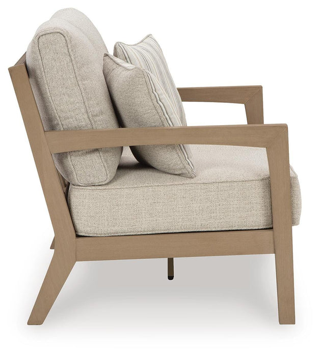 Hallow Creek Outdoor Loveseat with Cushion - Home Furniture And More (Brentwood, MD)